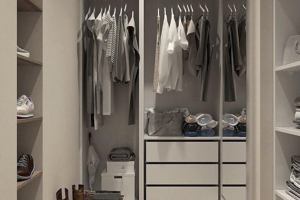 assorted clothes hanged inside cabinet