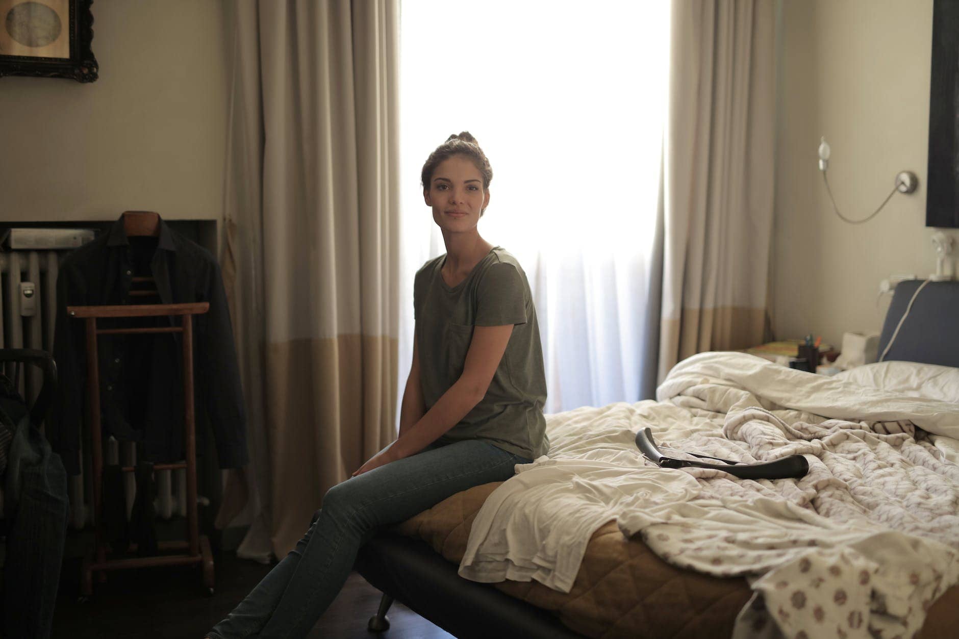 woman sitting on bed